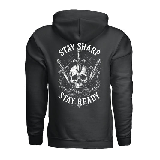 A black pullover hoodie shown from the back, featuring a large white graphic print of a skull, crossed swords, and the words 'STAY SHARP' and 'STAY READY'.